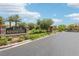A street view of the Stonegate community entrance with a sign, manicured greenery, and security gates at 9410 Stone Castle Way, Las Vegas, NV 89123