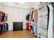 Spacious walk-in closet with ample storage, including hanging racks, shelves, and a three-drawer dresser at 9410 Stone Castle Way, Las Vegas, NV 89123