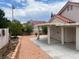 Landscaped backyard with stone covered ground, stone flower beds, covered patio, and desert landscaping at 9600 Pacific View Dr, Las Vegas, NV 89117