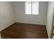 Bedroom with laminate flooring and a bright window overlooking the yard at 9600 Pacific View Dr, Las Vegas, NV 89117