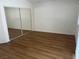 Empty bedroom with laminate floors and modern sliding mirrored closet door at 9600 Pacific View Dr, Las Vegas, NV 89117