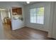 Dining room features hardwood floors, a large window, and an open view to the kitchen at 9600 Pacific View Dr, Las Vegas, NV 89117