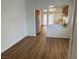 Dining room features hardwood floors, a large window, and an open view to the kitchen at 9600 Pacific View Dr, Las Vegas, NV 89117