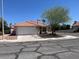 Inviting single-story home featuring a tiled roof, desert landscaping, and an attached two-car garage at 9600 Pacific View Dr, Las Vegas, NV 89117