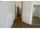 Hallway with laminate floors leading to bedrooms and an entrance to a bathroom at 9600 Pacific View Dr, Las Vegas, NV 89117
