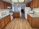 Open kitchen with wooden cabinets, white appliances and breakfast bar at 9600 Pacific View Dr, Las Vegas, NV 89117