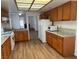 Spacious kitchen with wood cabinets, granite countertops, stainless steel appliances, and hardwood floors at 9600 Pacific View Dr, Las Vegas, NV 89117