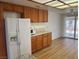 Bright kitchen area with white refrigerator, microwave, and granite countertops at 9600 Pacific View Dr, Las Vegas, NV 89117