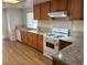 Kitchen featuring wood cabinets, granite countertops, stainless steel appliances, and hardwood floors at 9600 Pacific View Dr, Las Vegas, NV 89117