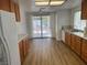 Well-lit kitchen with wood cabinets, granite countertops, stainless steel appliances, and hardwood floors at 9600 Pacific View Dr, Las Vegas, NV 89117