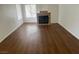Living room featuring hardwood floors, a fireplace, and a large window with natural light at 9600 Pacific View Dr, Las Vegas, NV 89117