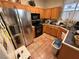 Well-lit kitchen features stainless steel appliances, tile flooring, and natural wood cabinetry at 977 Country Skies Ave, Las Vegas, NV 89123
