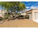 Lush landscaping in backyard with mature tree and gravel ground cover surrounding a bright and sunny home at 10009 Netherton Dr, Las Vegas, NV 89134