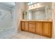 Bright bathroom featuring a double sink vanity and a separate walk-in shower at 10009 Netherton Dr, Las Vegas, NV 89134