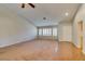 Bright living room with neutral walls, plantation shutters, and a mix of carpet and wood flooring at 10009 Netherton Dr, Las Vegas, NV 89134
