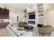 Staged living room with a fireplace, shelving, and designer decor at 10179 Emerald Sunset Ct, Las Vegas, NV 89148