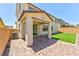 Backyard patio featuring brick flooring, artificial turf, and an overhang, perfect for outdoor entertaining at 10270 Turkish Pine Ct, Las Vegas, NV 89166