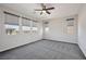 Bedroom featuring several windows, ceiling fan, and gray carpet at 10270 Turkish Pine Ct, Las Vegas, NV 89166