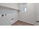 Laundry room with wood-look flooring and built in shelving at 10270 Turkish Pine Ct, Las Vegas, NV 89166