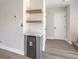 Built in dry bar with modern floating shelves, lower cabinets, and a mini beverage cooler at 1097 Paradise Resort Dr, Henderson, NV 89002