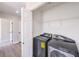 Well-lit laundry room with modern washer and dryer and wire shelving at 1097 Paradise Resort Dr, Henderson, NV 89002