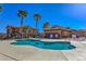 Community pool with palm trees and lounge chairs for a resort-style living experience at 1097 Paradise Resort Dr, Henderson, NV 89002