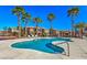 Community pool surrounded by lush palm trees and sun loungers on a bright, sunny day at 1097 Paradise Resort Dr, Henderson, NV 89002
