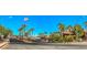 A street view of a well maintained community with palm trees and red-tiled roofs under a bright blue sky at 1097 Paradise Resort Dr, Henderson, NV 89002