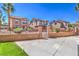 Gated yard featuring lush landscaping and a driveway leading to the home at 1097 Paradise Resort Dr, Henderson, NV 89002