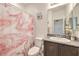 Well-lit bathroom featuring a granite countertop, modern sink, and stylish shower curtain at 1120 Tektite Ave, Henderson, NV 89011