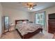 Relaxing bedroom featuring a ceiling fan, window with natural light, and dresser for ample storage at 1120 Tektite Ave, Henderson, NV 89011