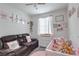 Charming Bedroom with a sofa, crib, dresser and pink themed decor at 1120 Tektite Ave, Henderson, NV 89011