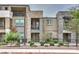 Modern multi-level townhome with stone and siding, showcasing a manicured front yard and wrought iron fence at 1120 Tektite Ave, Henderson, NV 89011