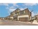 Street view of modern townhomes with garages, showcasing a well-maintained street at 1120 Tektite Ave, Henderson, NV 89011