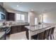 Modern kitchen with stainless steel appliances, granite countertops, and a breakfast bar at 1120 Tektite Ave, Henderson, NV 89011