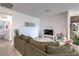 Cozy living room with a large sofa, adjacent to a modern kitchen and dining area at 1120 Tektite Ave, Henderson, NV 89011