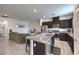 Bright, open-concept living space with a kitchen featuring granite countertops and stainless appliances at 1120 Tektite Ave, Henderson, NV 89011