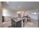 Open-concept kitchen and living area with stainless appliances and tile floors at 1120 Tektite Ave, Henderson, NV 89011