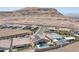 Overhead view of homes in the community, with a large mountain range, one featuring a pool and solar panels at 11248 Rebel Dome Ct, Las Vegas, NV 89141