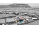 Black and white aerial view of homes in a desert community, showcasing a pool and mountain backdrop at 11248 Rebel Dome Ct, Las Vegas, NV 89141