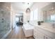 This contemporary bathroom offers dual vanities, soaking tub, and marble shower at 11248 Rebel Dome Ct, Las Vegas, NV 89141