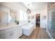 A luxurious bathroom with dual vanities, soaking tub, and a glass enclosed shower at 11248 Rebel Dome Ct, Las Vegas, NV 89141