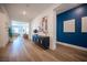 Bright foyer with wood floors, stylish console table, artwork, and views of the living spaces at 11248 Rebel Dome Ct, Las Vegas, NV 89141