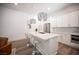 Bright, modern kitchen with a large island, marble countertops, stainless steel appliances, and chic pendant lighting at 11248 Rebel Dome Ct, Las Vegas, NV 89141