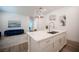Modern kitchen island featuring marble countertops, a sink, pendant lighting, and an open layout to the living room at 11248 Rebel Dome Ct, Las Vegas, NV 89141