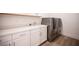 Clean laundry room with modern washer and dryer and white countertops at 11248 Rebel Dome Ct, Las Vegas, NV 89141