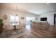 Spacious living room and dining area with wood-look floors and access to the outdoor patio at 11248 Rebel Dome Ct, Las Vegas, NV 89141