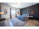This main bedroom offers a decorative wall, cozy bed, and bright natural light at 11248 Rebel Dome Ct, Las Vegas, NV 89141