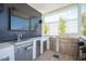 Outdoor kitchen featuring stainless steel appliances, including a grill, sink, and storage, ideal for entertaining at 11248 Rebel Dome Ct, Las Vegas, NV 89141