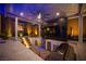 Outdoor kitchen and bar area with built in grill, TV and seating at 11248 Rebel Dome Ct, Las Vegas, NV 89141